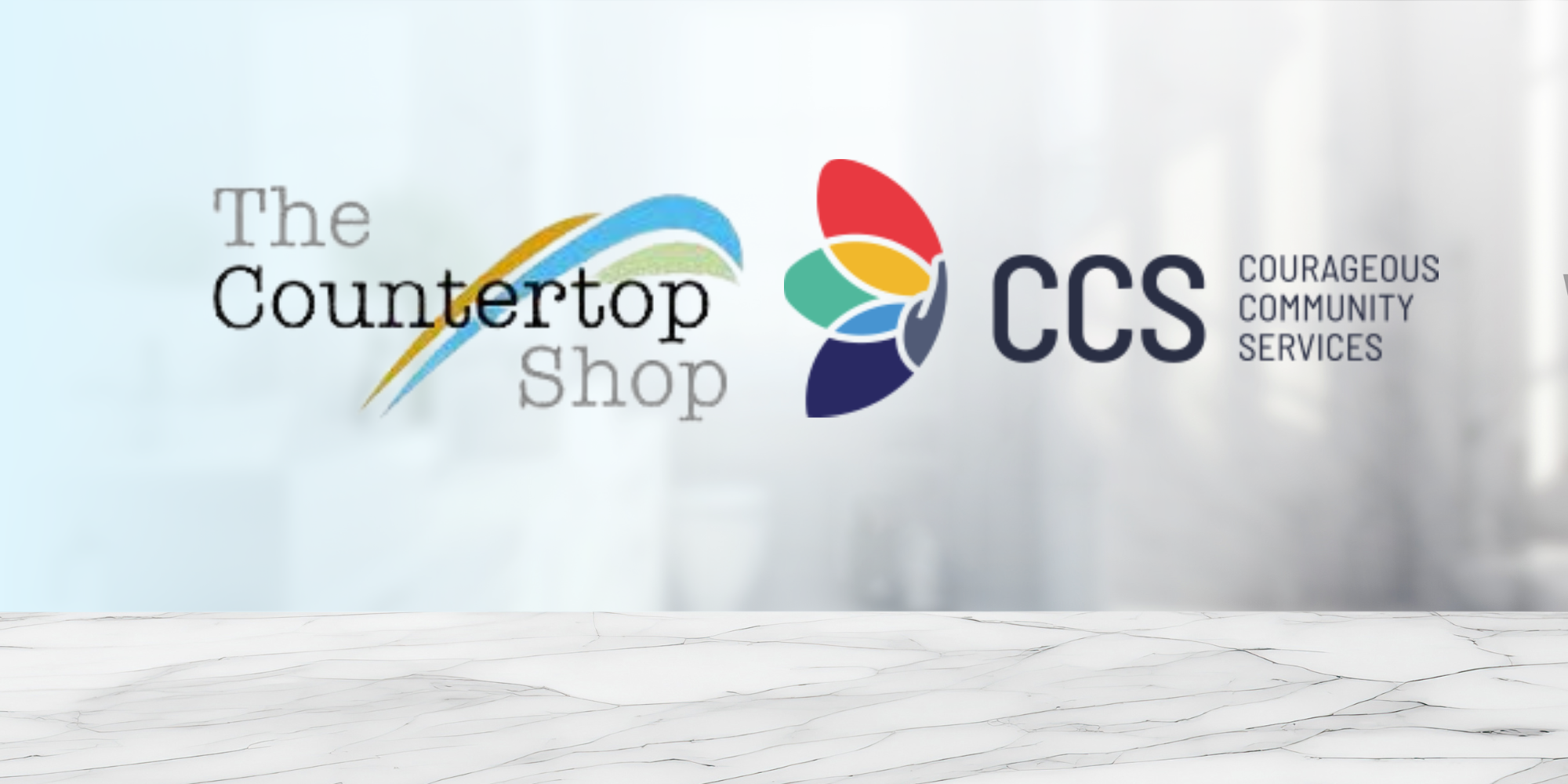 A banner image of a marble countertop in a hazy, blurred kitchen. The Countertop Shop and CCS's logos are featured prominently.